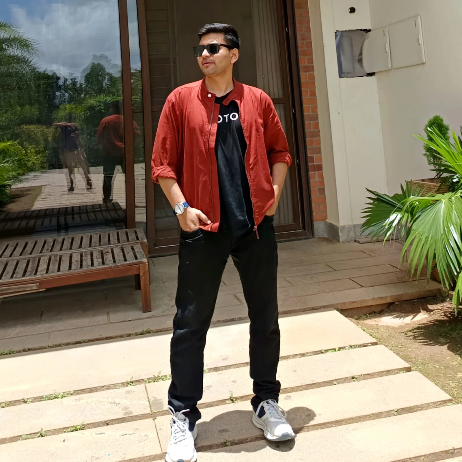 Safdar Ali standing in an Airbnb wearing sunglasses on a trip Safdar Ali standing in an Airbnb wearing sunglasses on a trip
